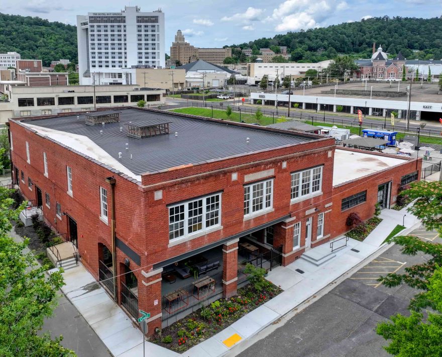 Historic red-brick Lofts at Creek Street building in downtown Hot Springs, shown from an aerial view near local restaurants and attractions