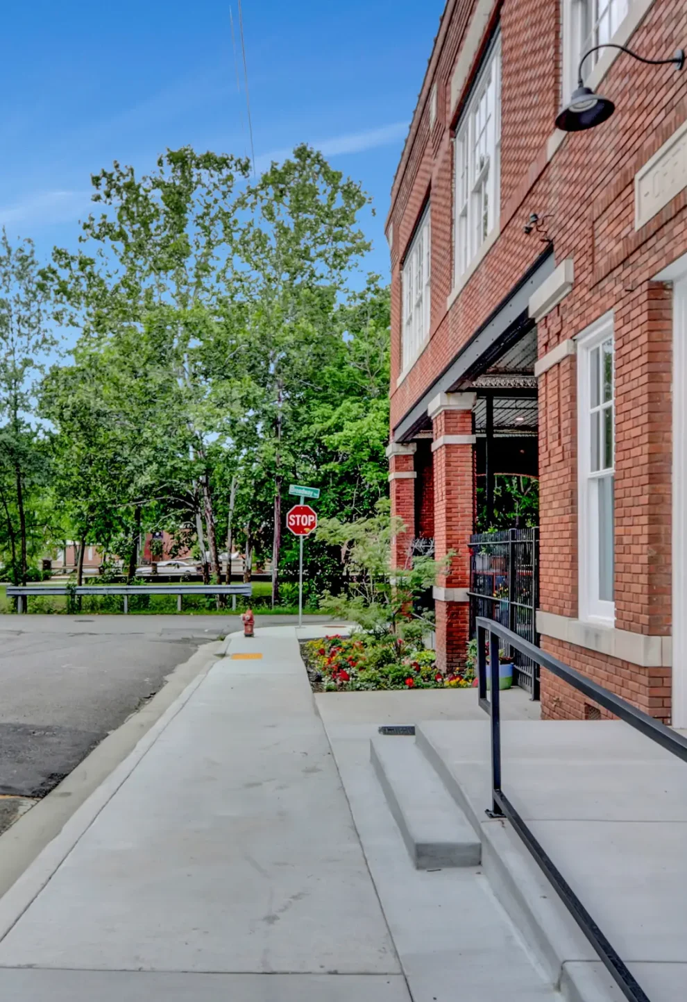 Exterior view of our Hot Springs Arkansas Condo Hotel, Lofts at Creek Street. Showing the historic brick facade and tree-lined park directly across from the building