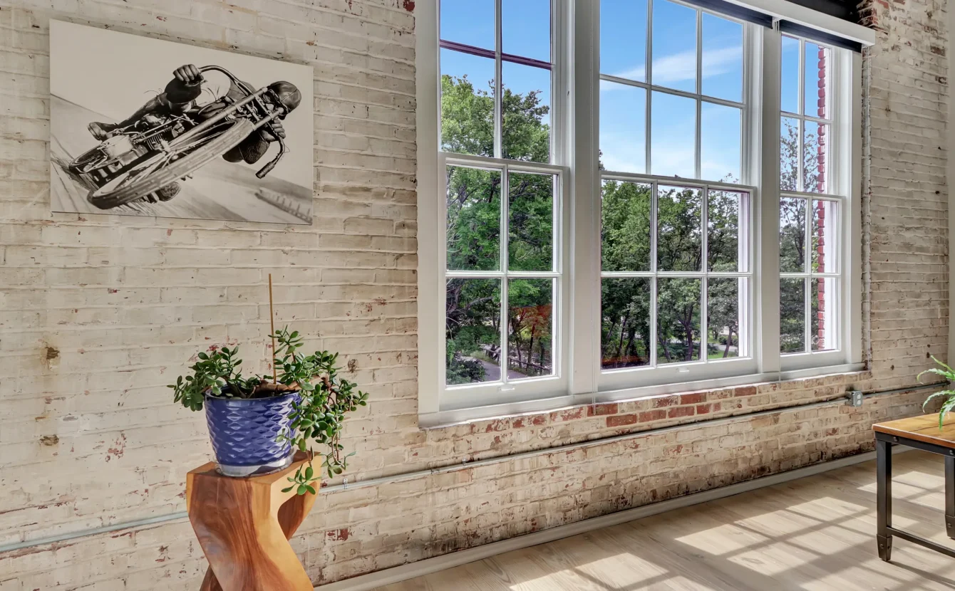 Large window with exposed brick and greenery views Downtown Hot Springs lodging