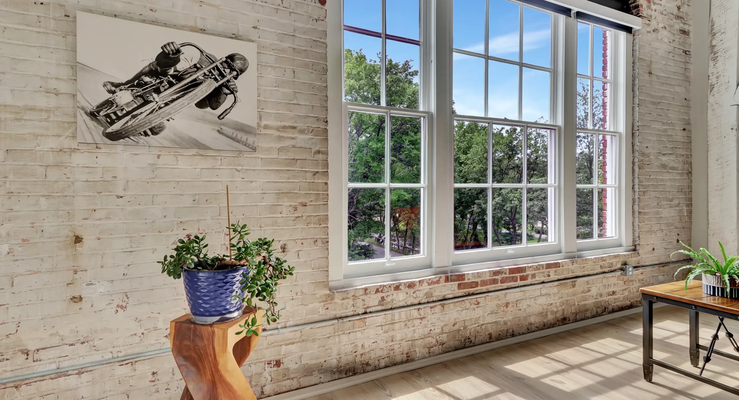 Large window with exposed brick and greenery views Downtown Hot Springs lodging