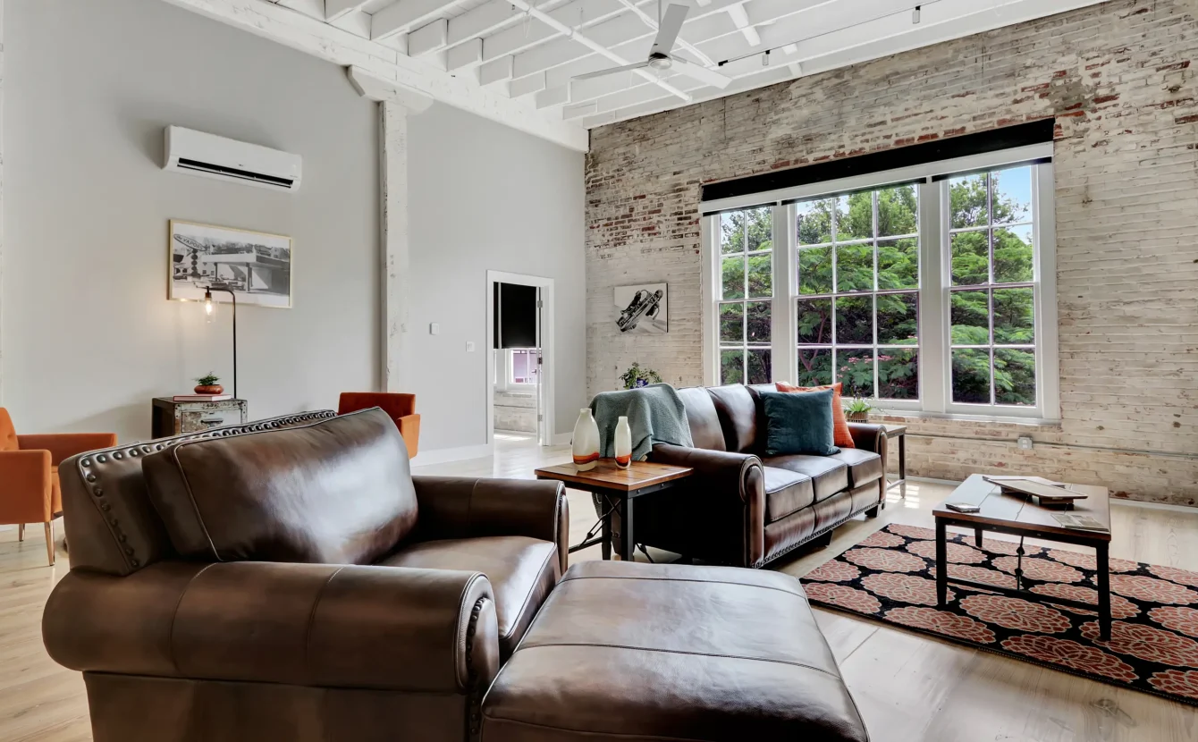Bright living room with exposed brick and large picture windows Hot Springs National Park lodging