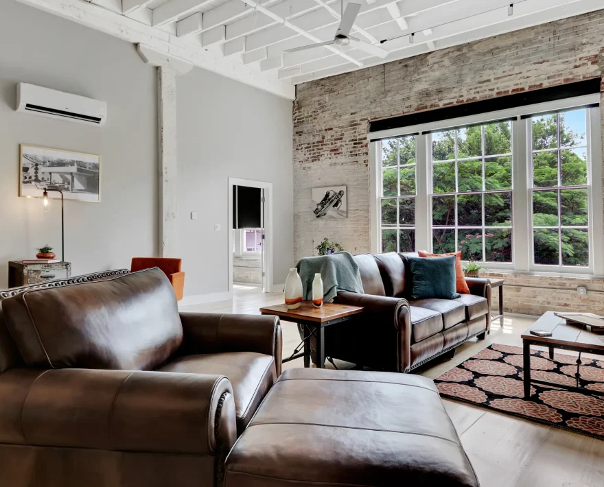 Bright living room with exposed brick and large picture windows Hot Springs National Park lodging