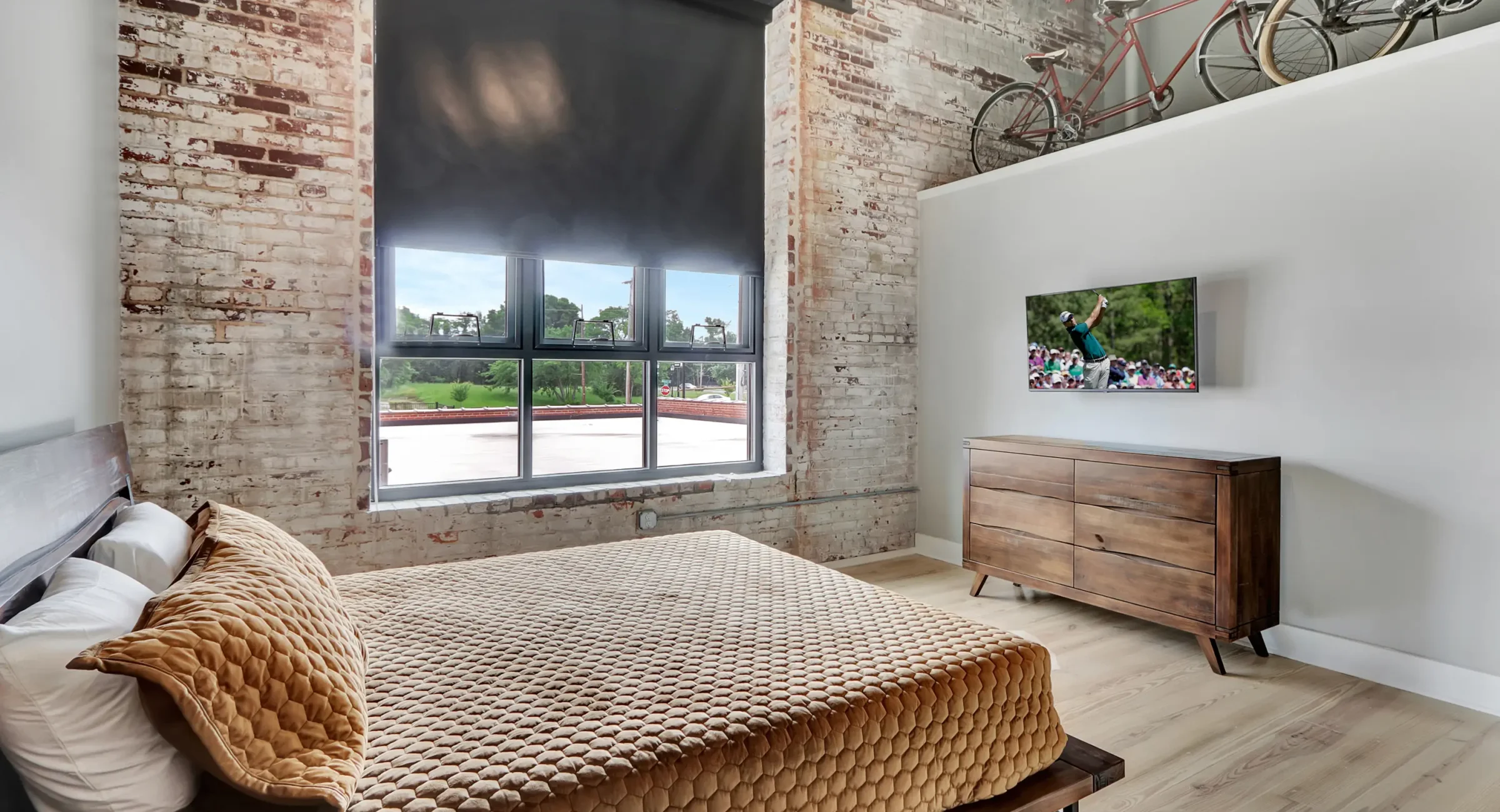Bedroom with oversized industrial windows and urban views Historic downtown Hot Springs rentals