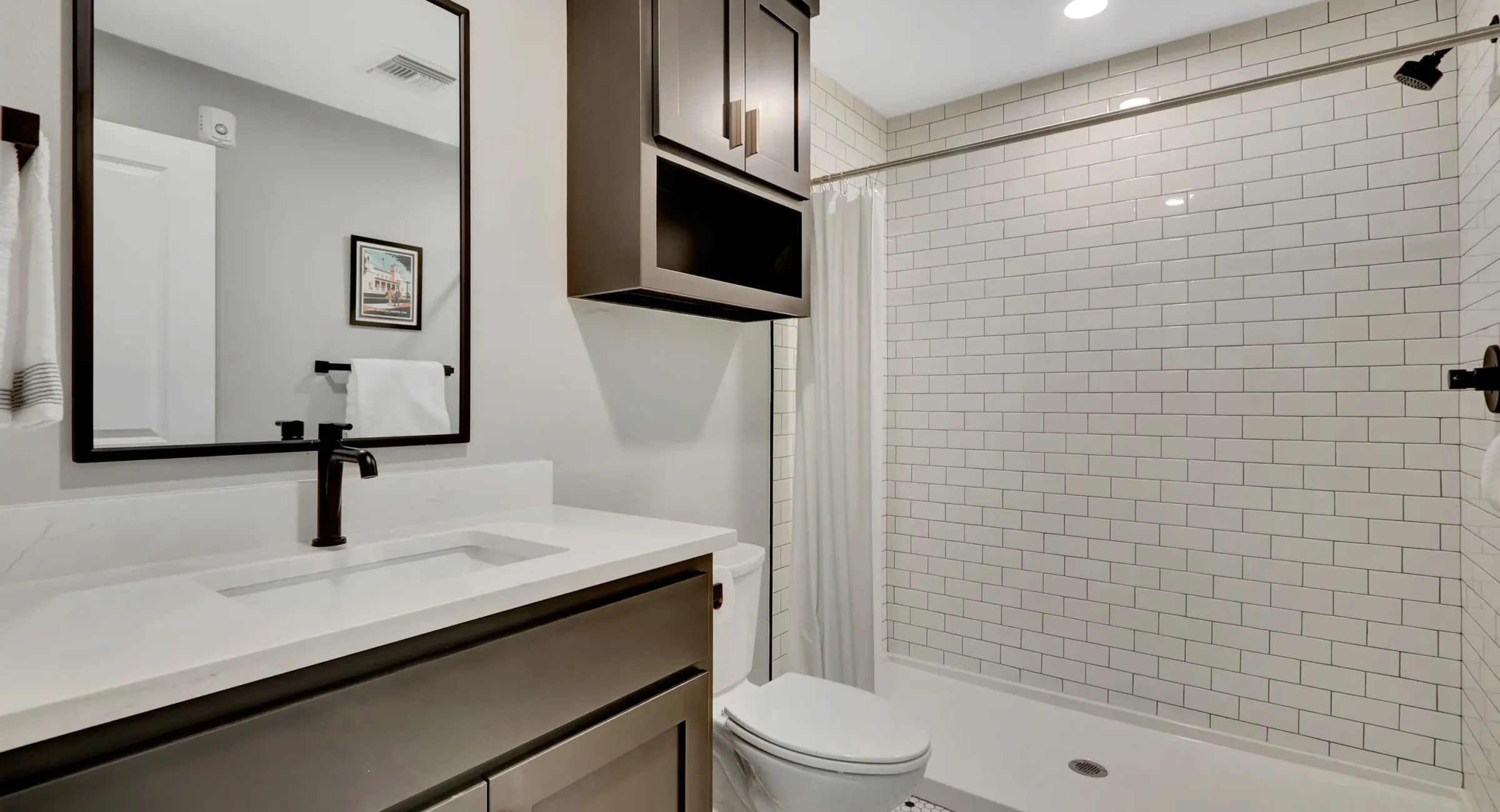 Modern bathroom with walk-in shower and subway tile Hot Springs accommodations