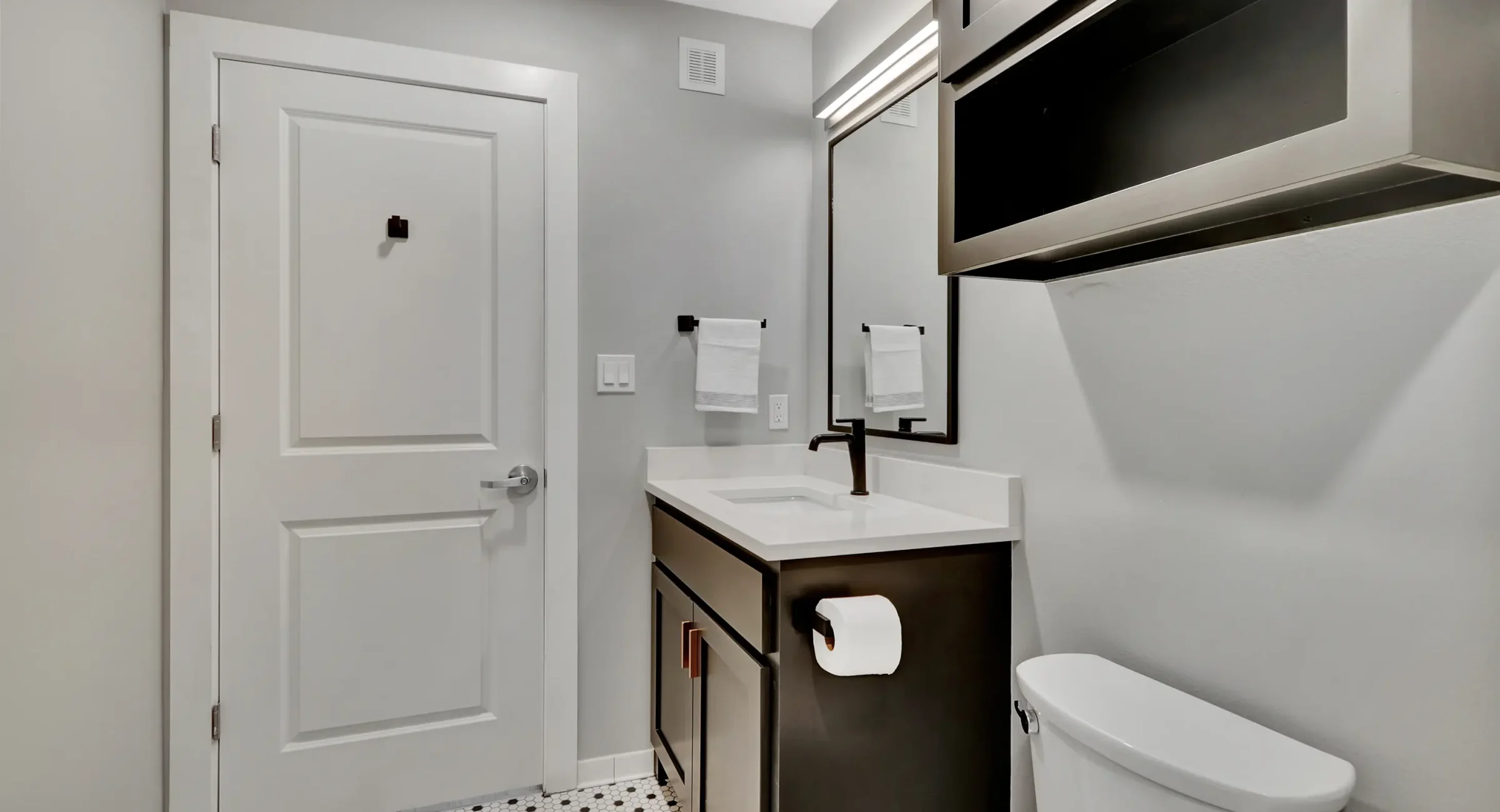 Bathroom vanity with matte black fixtures and bright lighting Ouachita Mountains lodging