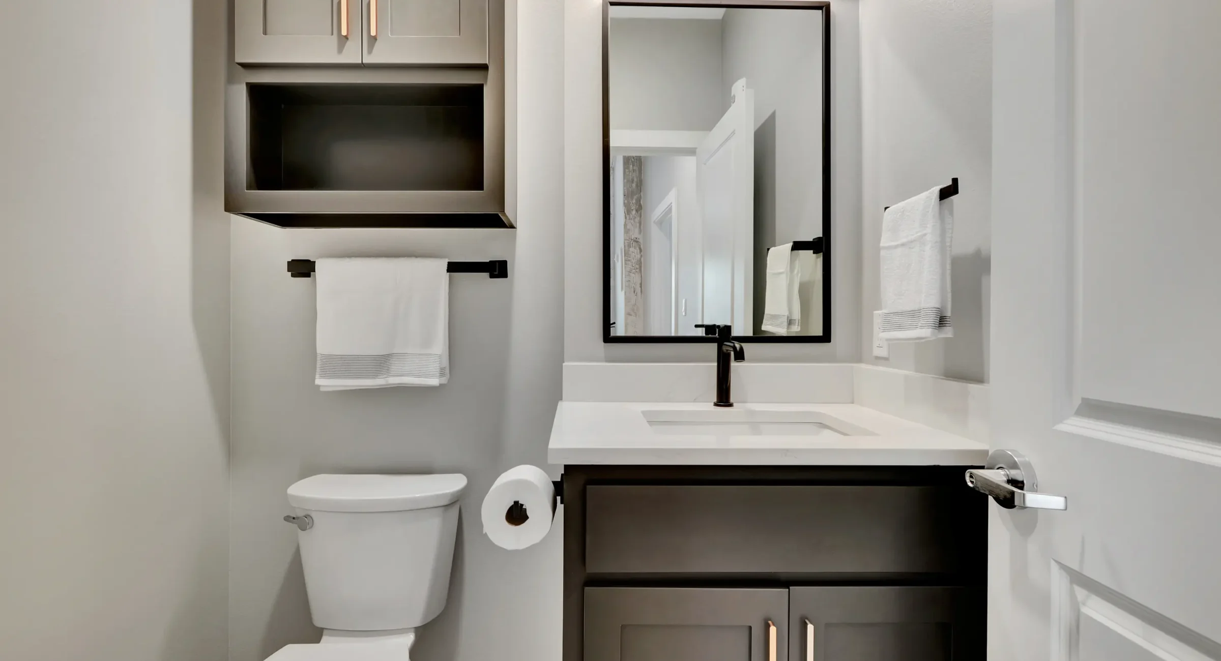 Modern half bathroom vanity with matte black fixtures at downtown Hot Springs lodging