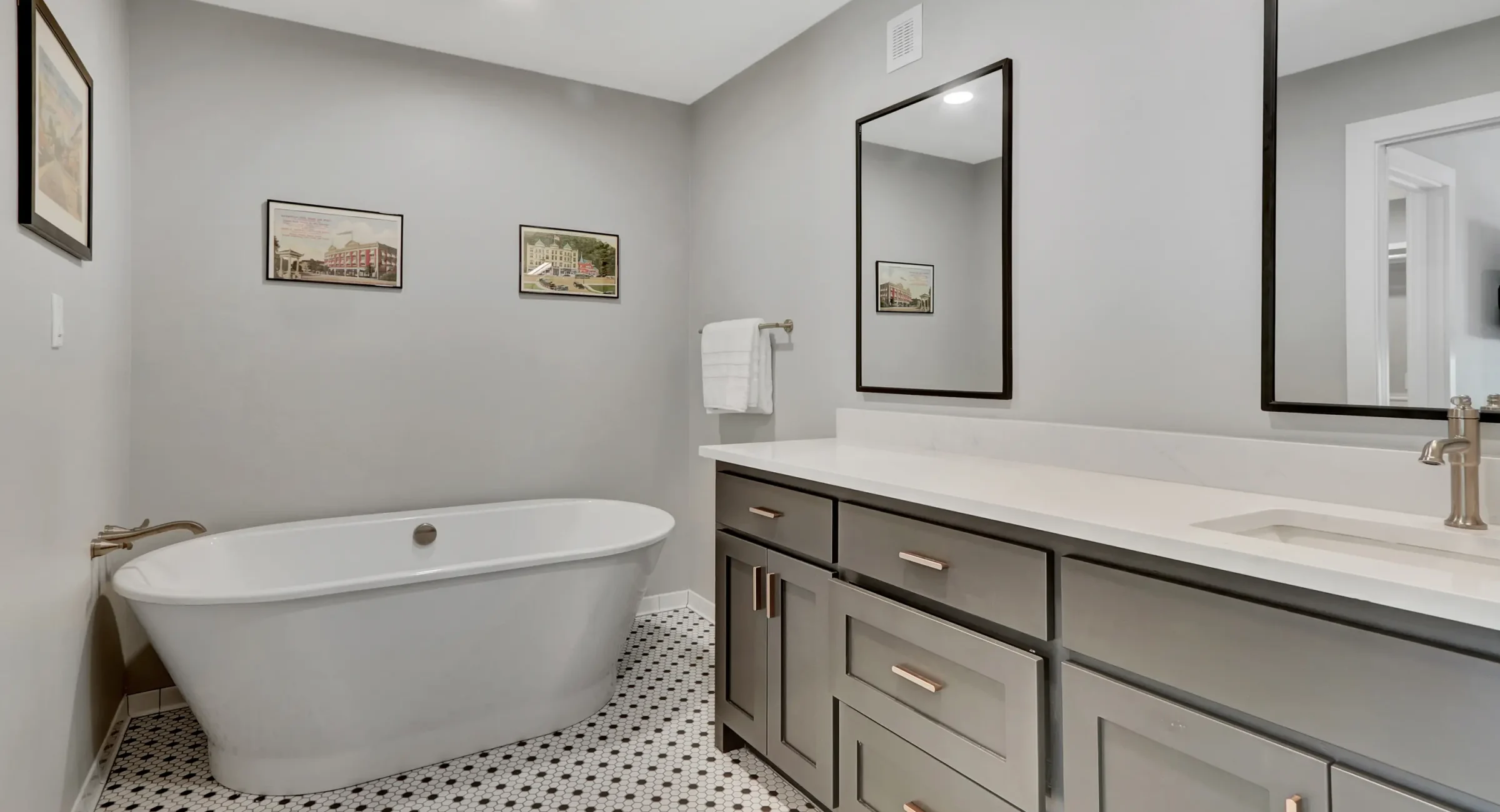Soaking tub and double-sink vanity inside a downtown Arkansas boutique hotel