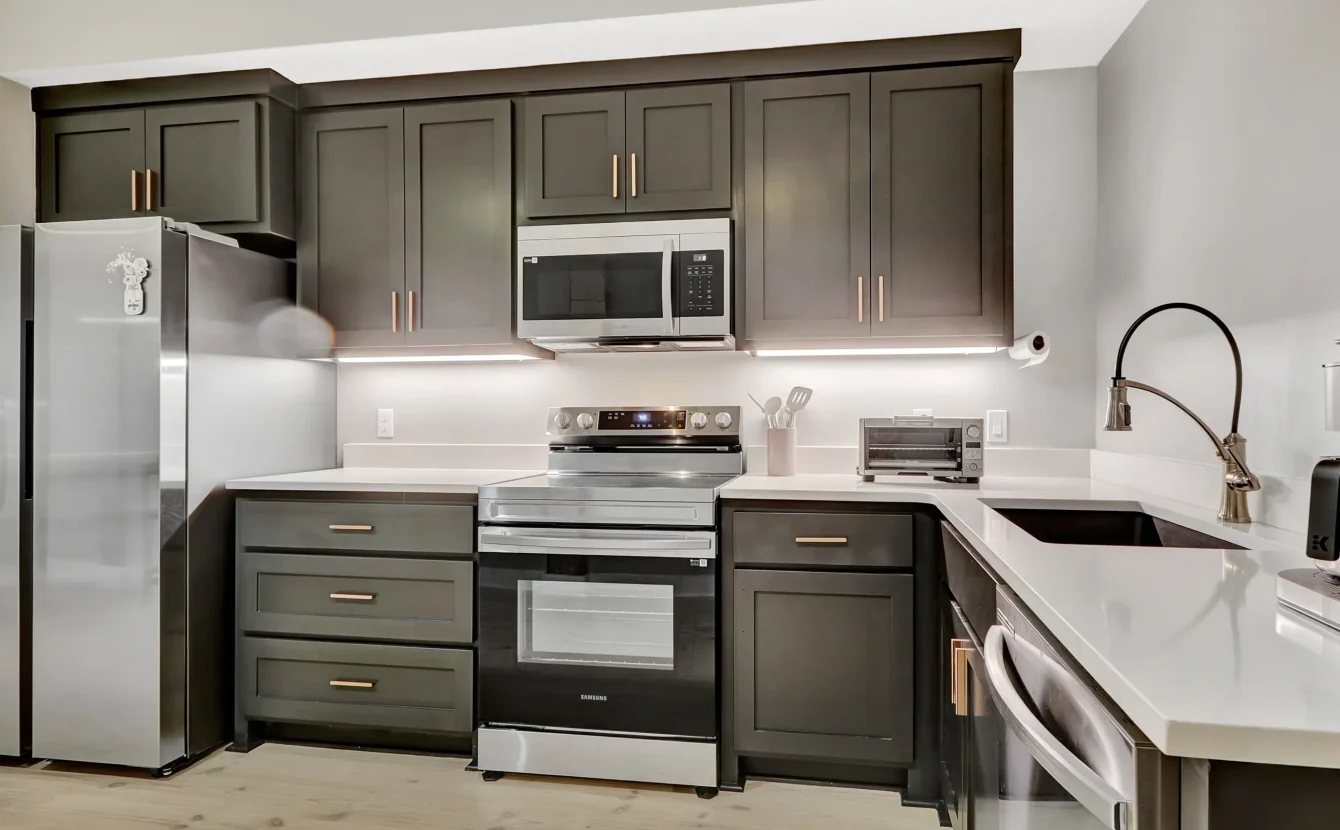Modern full kitchen in a downtown Hot Springs vacation rental with stainless appliances and dark cabinetry