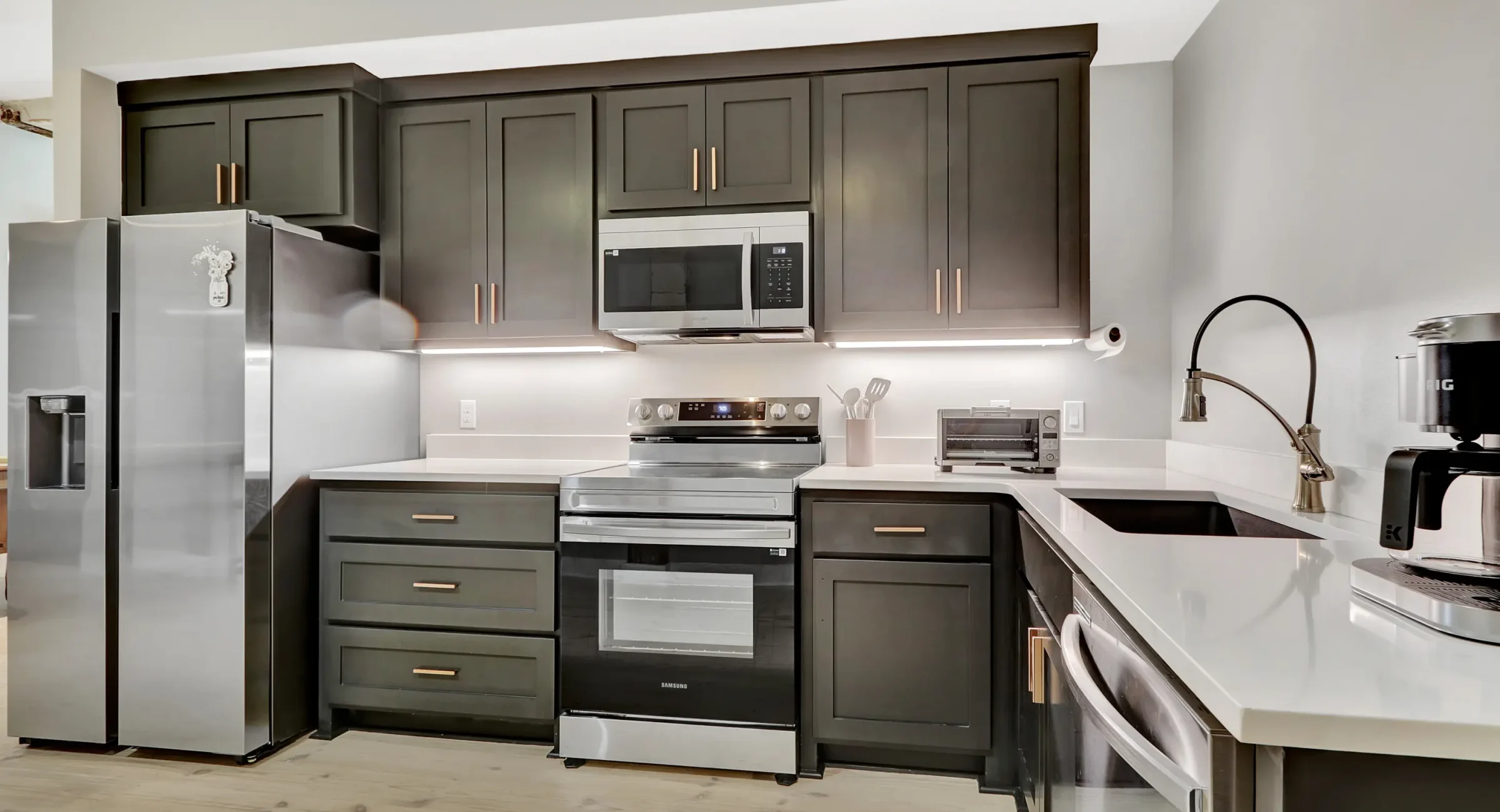 Modern full kitchen in a downtown Hot Springs vacation rental with stainless appliances and dark cabinetry