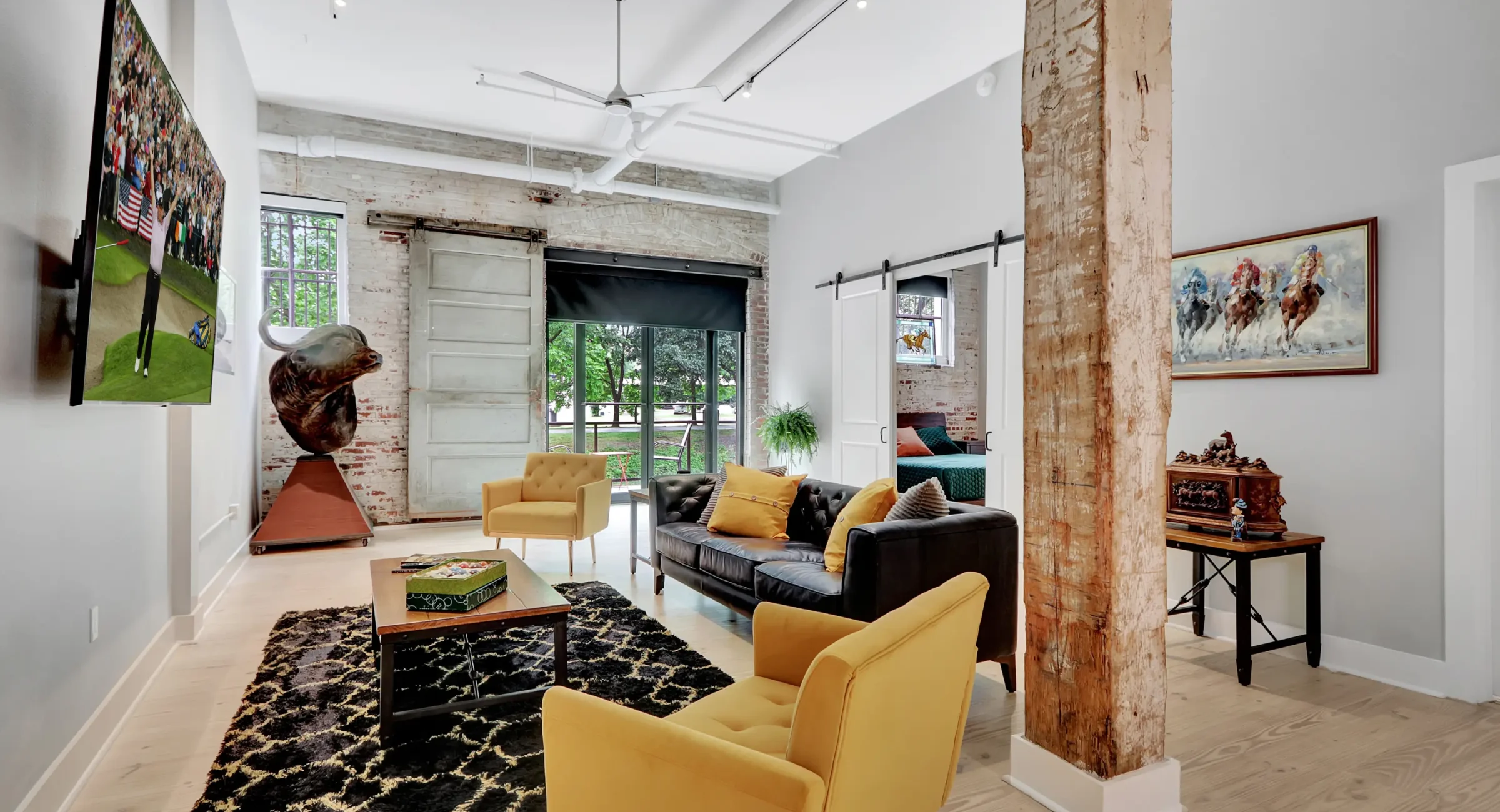 Spacious living area in a Hot Springs loft stay featuring exposed brick, eclectic décor, and comfortable seating