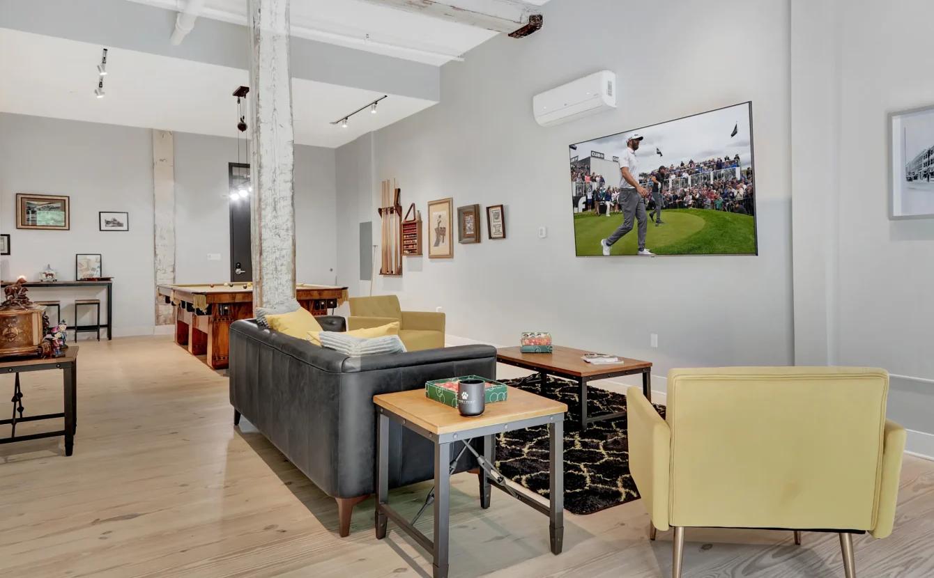 Open-concept Hot Springs loft rental with lounge seating and a vintage pool table