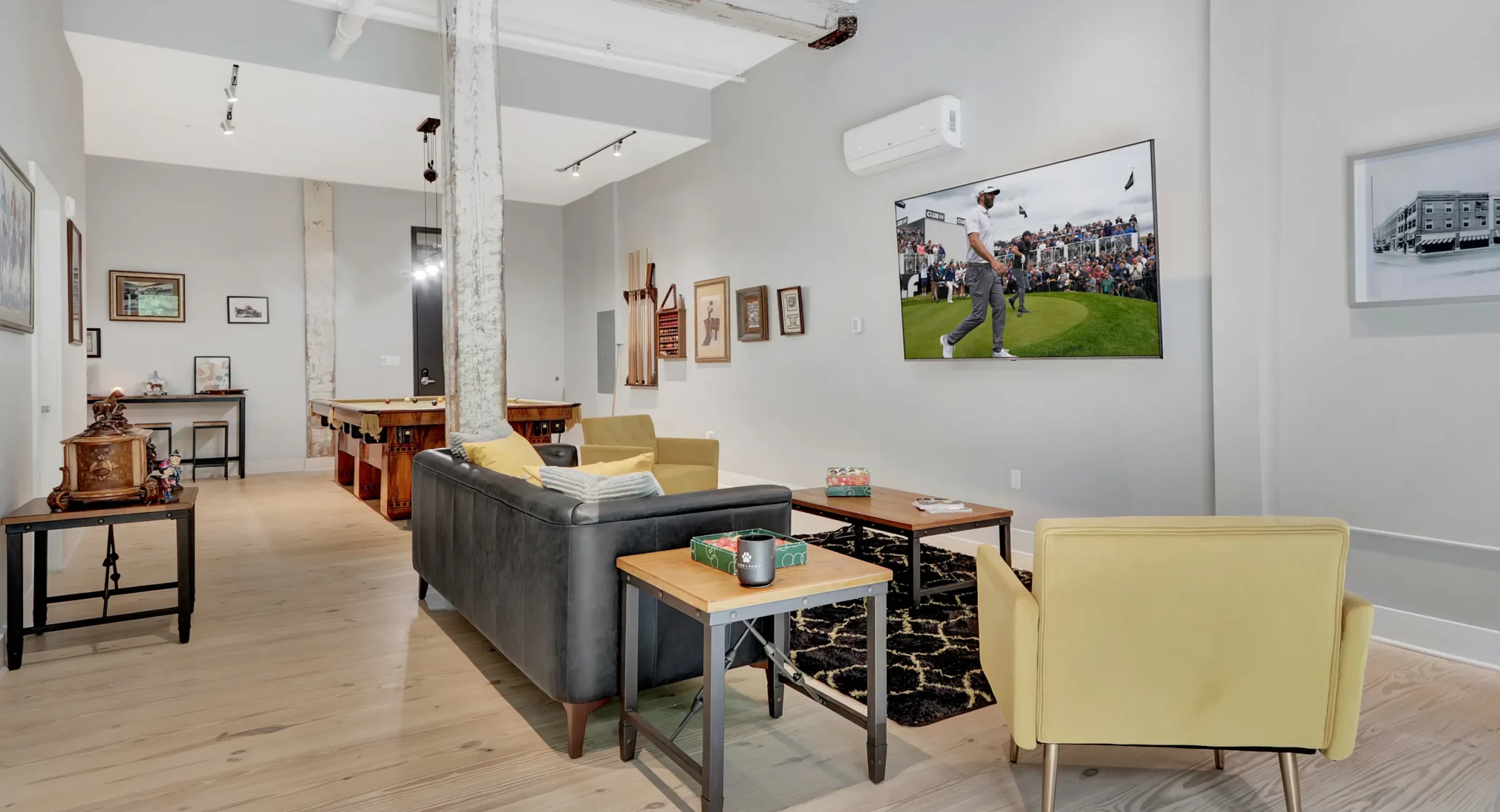 Open-concept Hot Springs loft rental with lounge seating and a vintage pool table