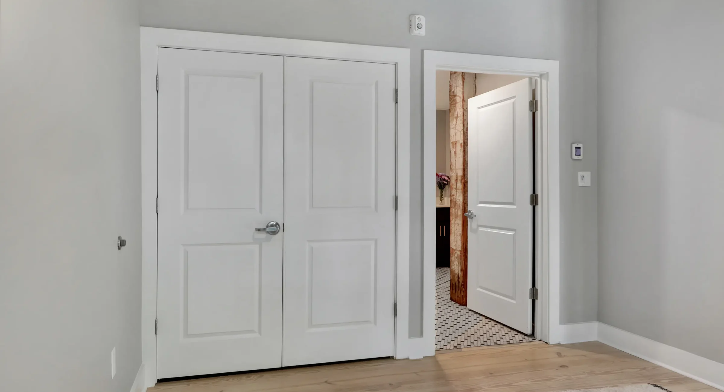 Bedroom interior in a downtown Hot Springs loft accommodation with closet storage and direct access to the bathroom