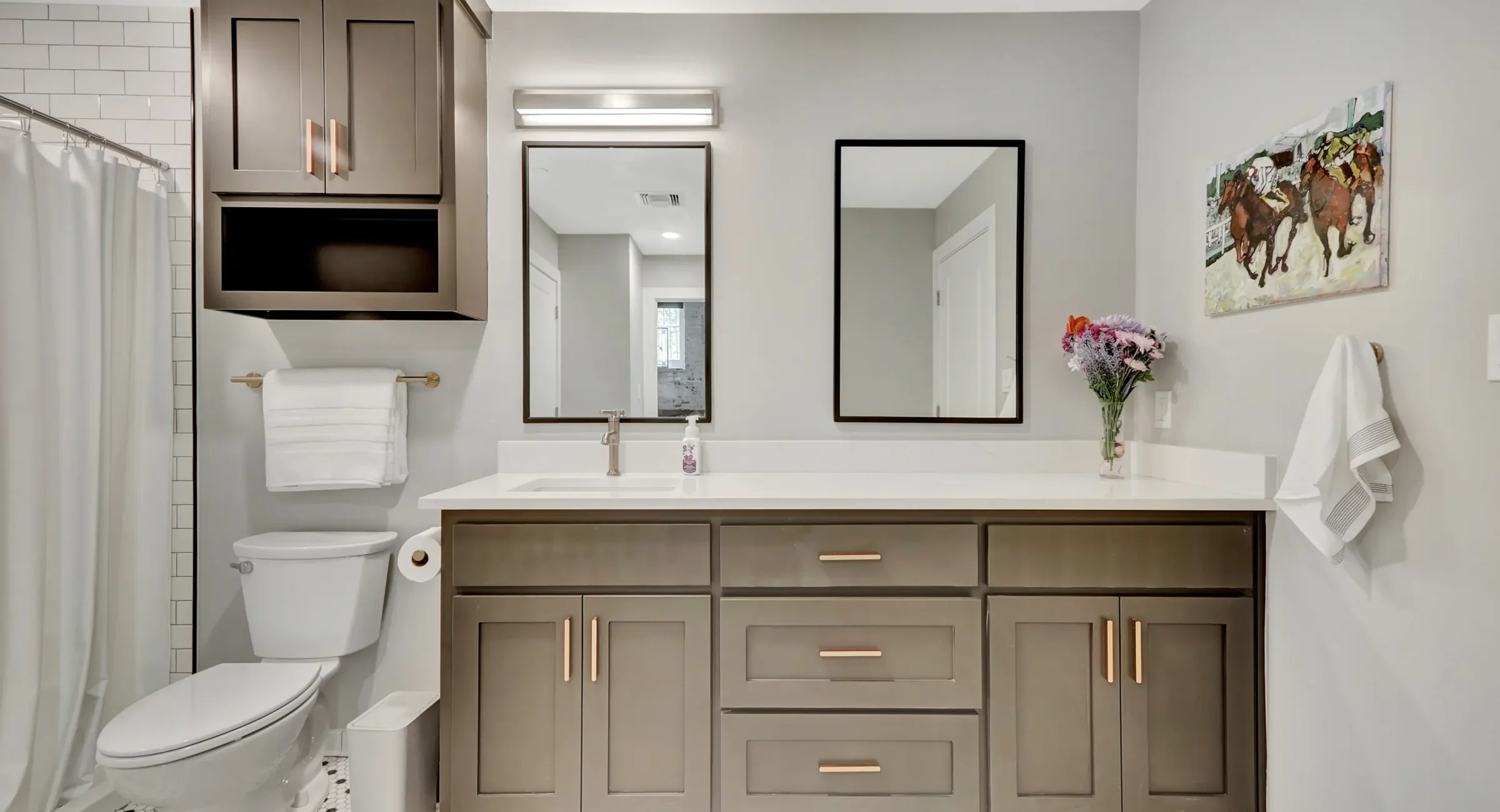 Modern bathroom in a downtown Hot Springs loft accommodation featuring a wide vanity, double mirrors, and contemporary finishes