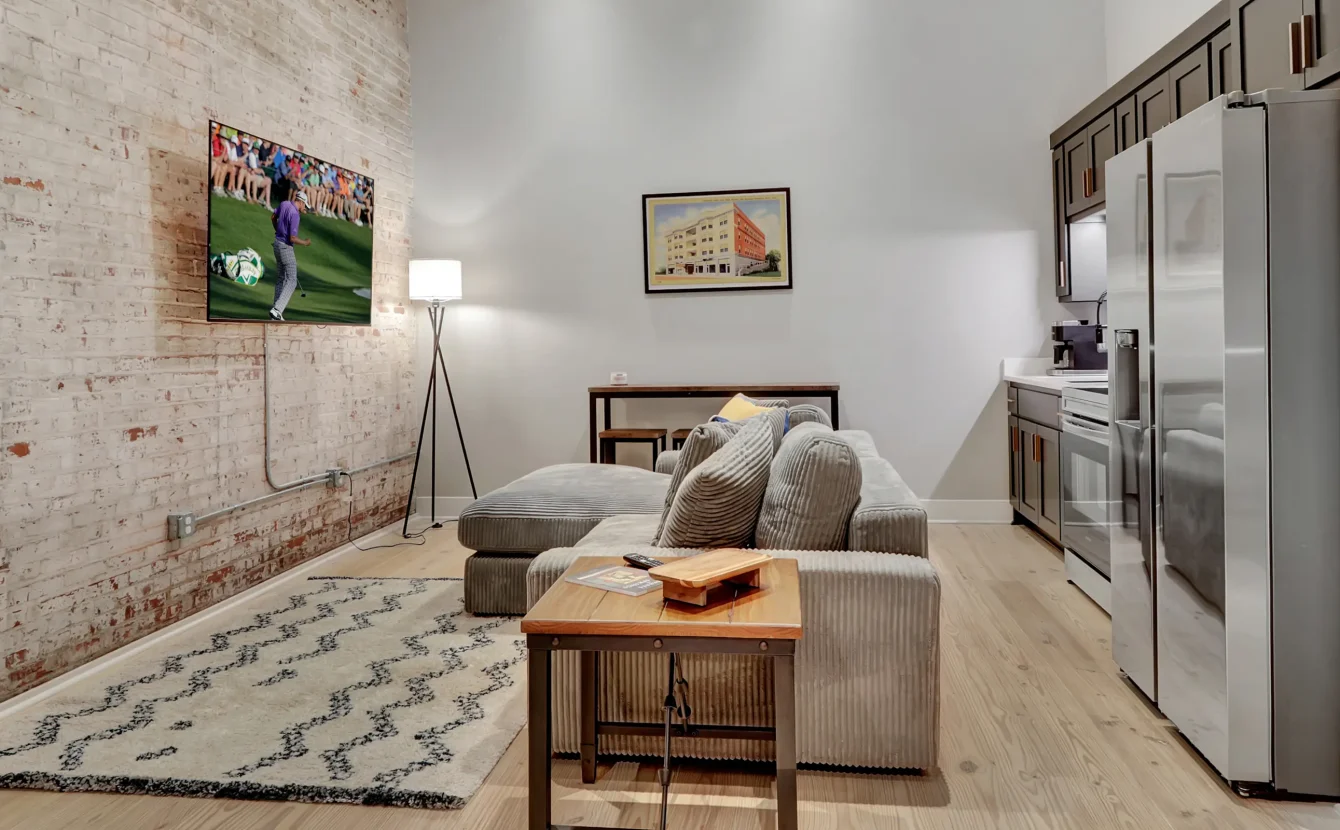 Open-concept living space in a Hot Springs AR vacation rental with exposed brick