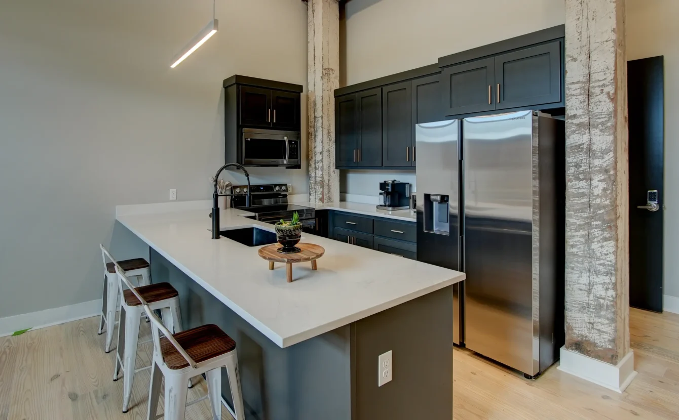 Modern kitchen inside a downtown Hot Springs accommodation featuring stainless steel appliances and a breakfast island