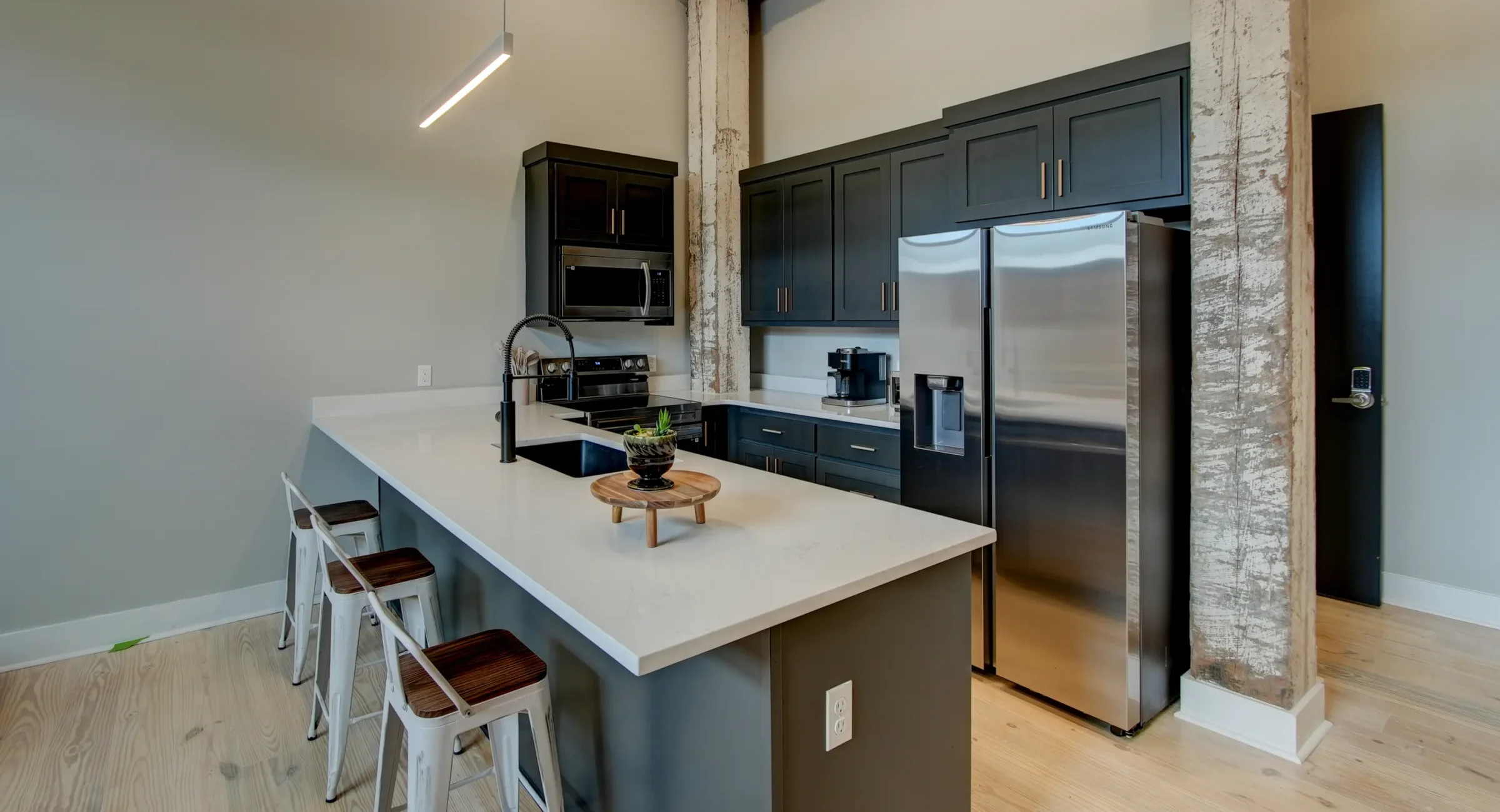 Modern kitchen inside a downtown Hot Springs accommodation featuring stainless steel appliances and a breakfast island