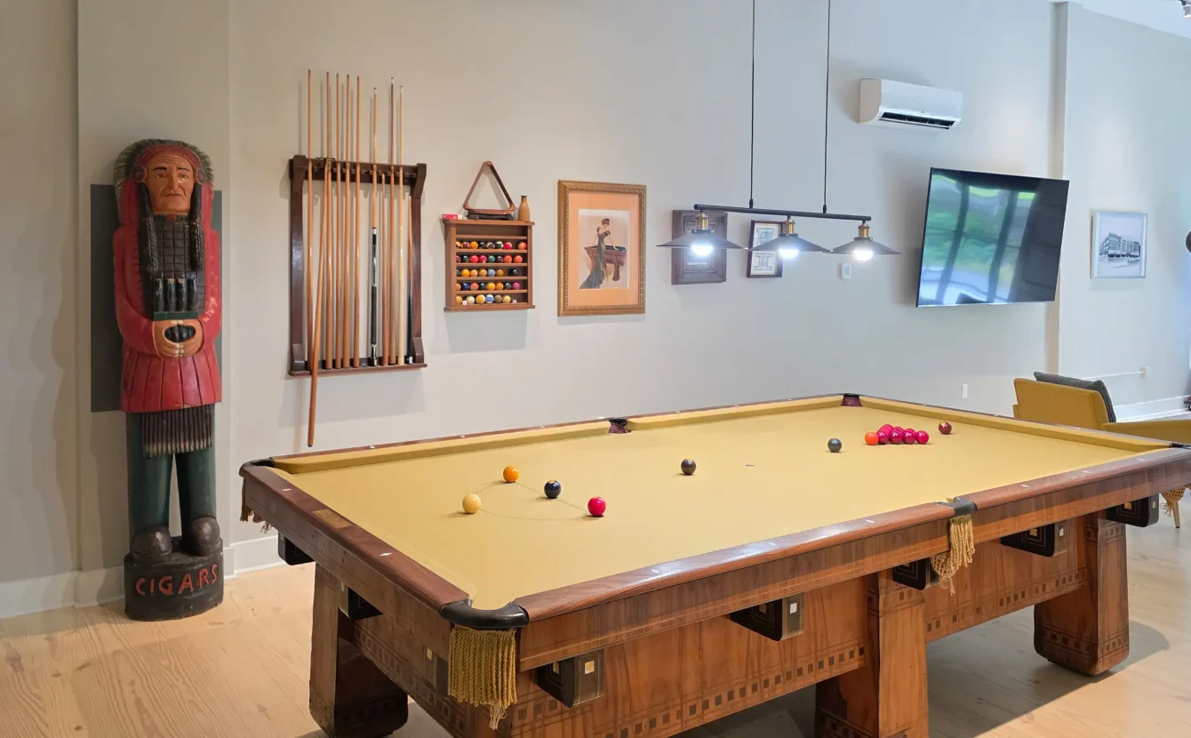 Open game area with a classic pool table inside a downtown Hot Springs lodging