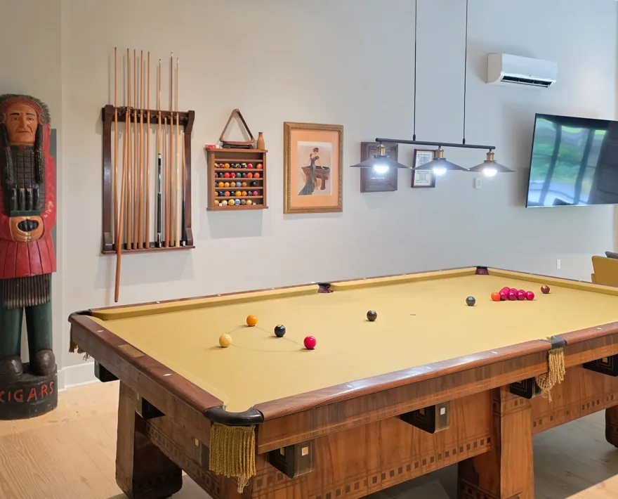 Open game area with a classic pool table inside a downtown Hot Springs lodging