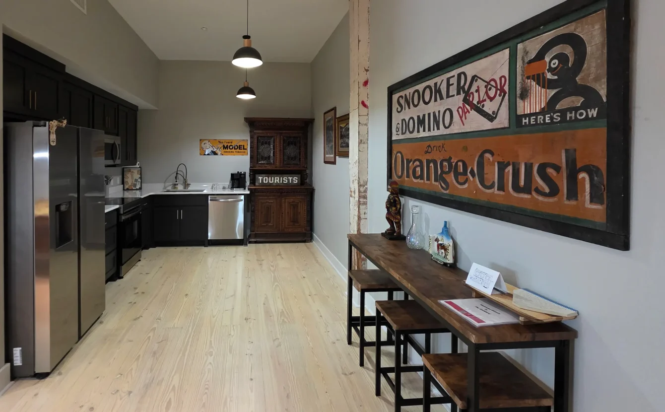 Full modern kitchen with stainless appliances and dark cabinetry inside a downtown Hot Springs accommodation