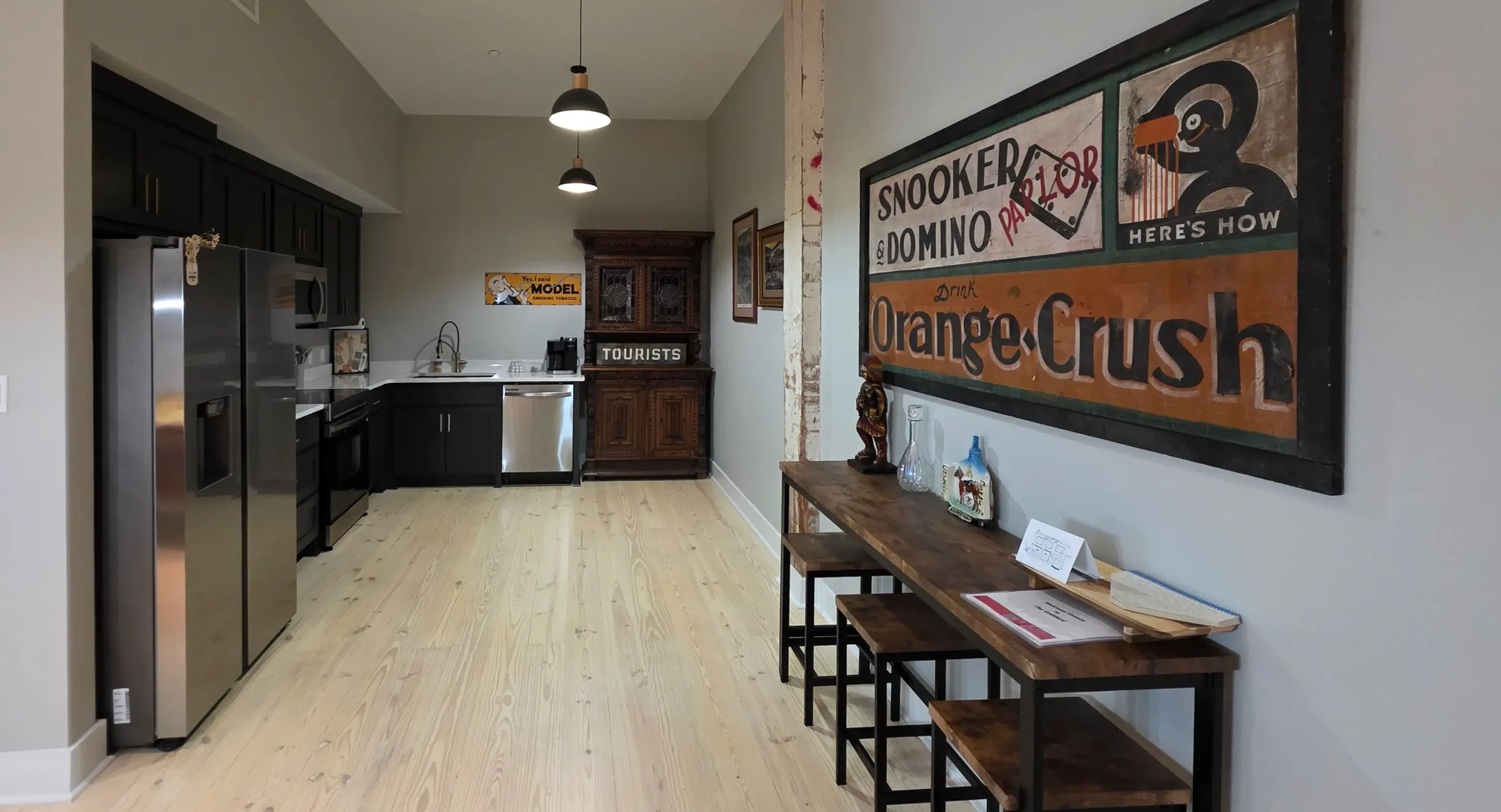 Full modern kitchen with stainless appliances and dark cabinetry inside a downtown Hot Springs accommodation