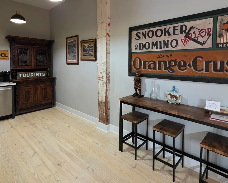 Kitchen and dining area in a renovated Hot Springs loft featuring historic wall décor and wood flooring