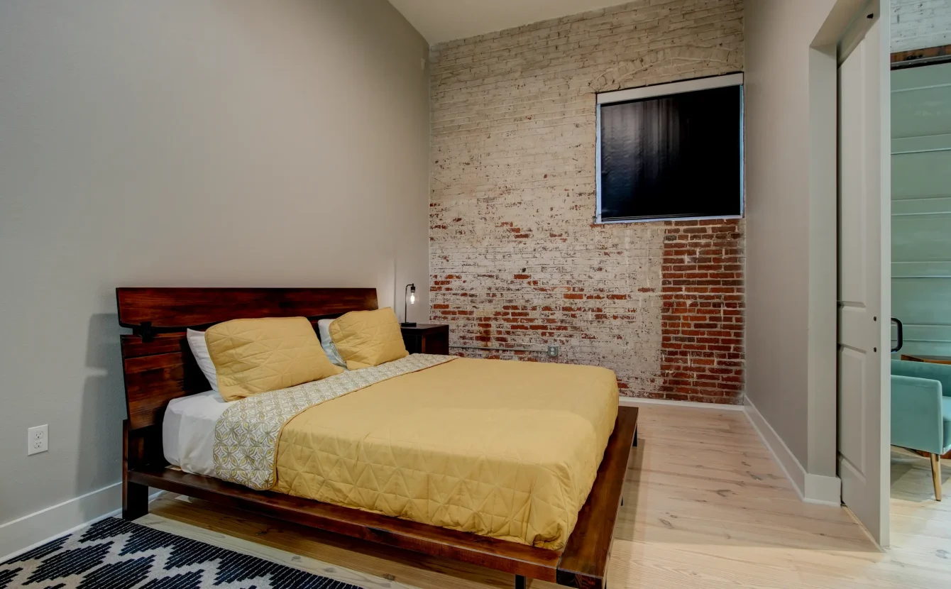 Bedroom with exposed brick wall in downtown Hot Springs