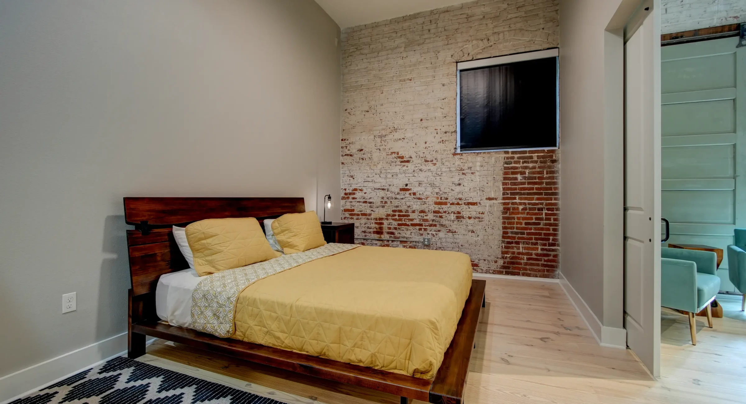 Bedroom with exposed brick wall in downtown Hot Springs