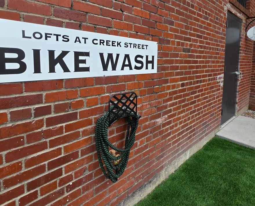 Bike wash station on the exterior of a Hot Springs accommodation offering cyclist-friendly amenities