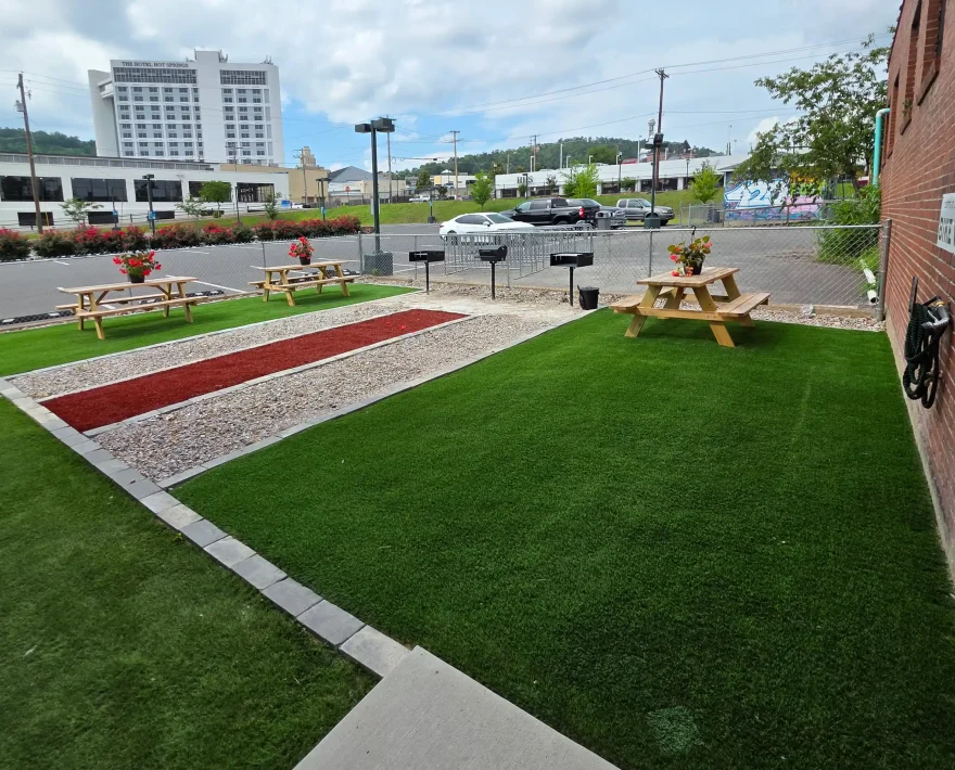 Guest courtyard featuring picnic tables and charcoal grills