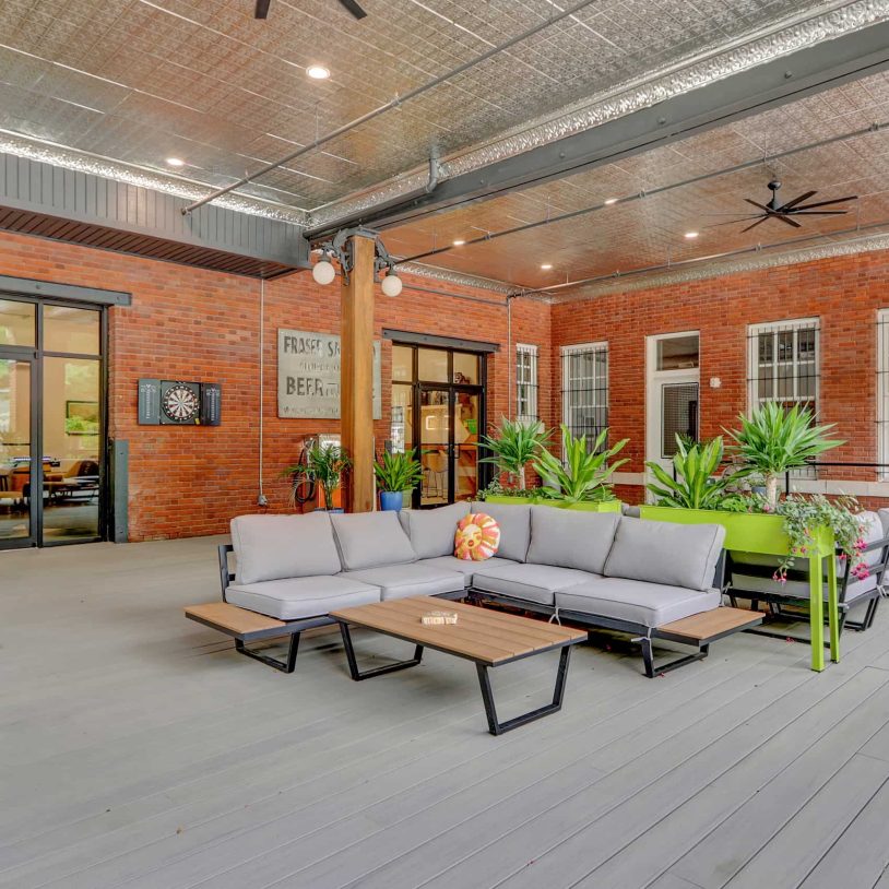 Guest patio at a restored historic Hot Springs hotel with brick archways, outdoor seating, and open-air gathering space