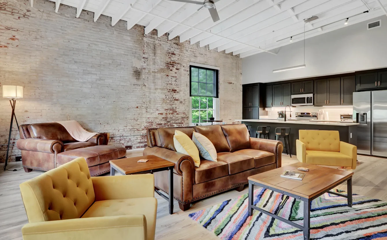 Spacious living area with exposed brick and oversized windows in downtown Hot Springs