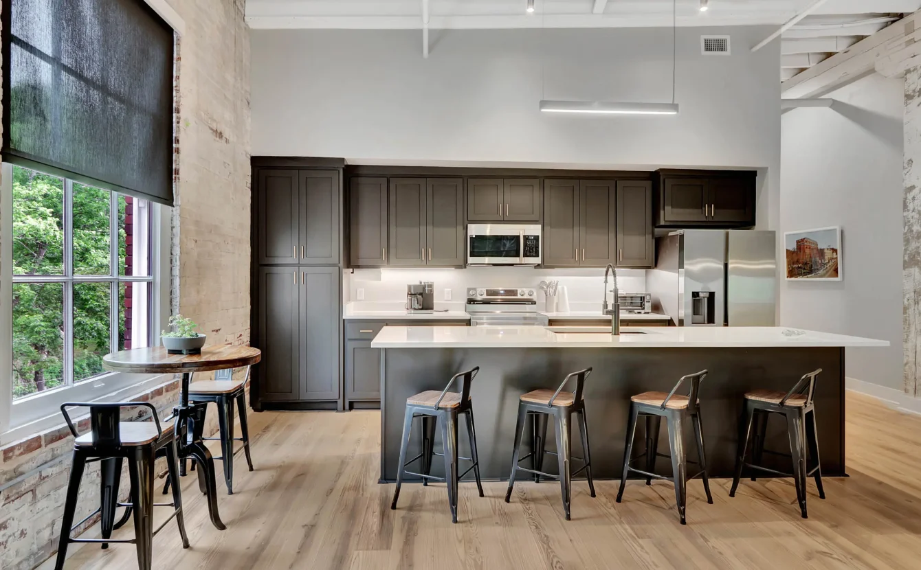 Modern kitchen with island seating inside a historic downtown Hot Springs building