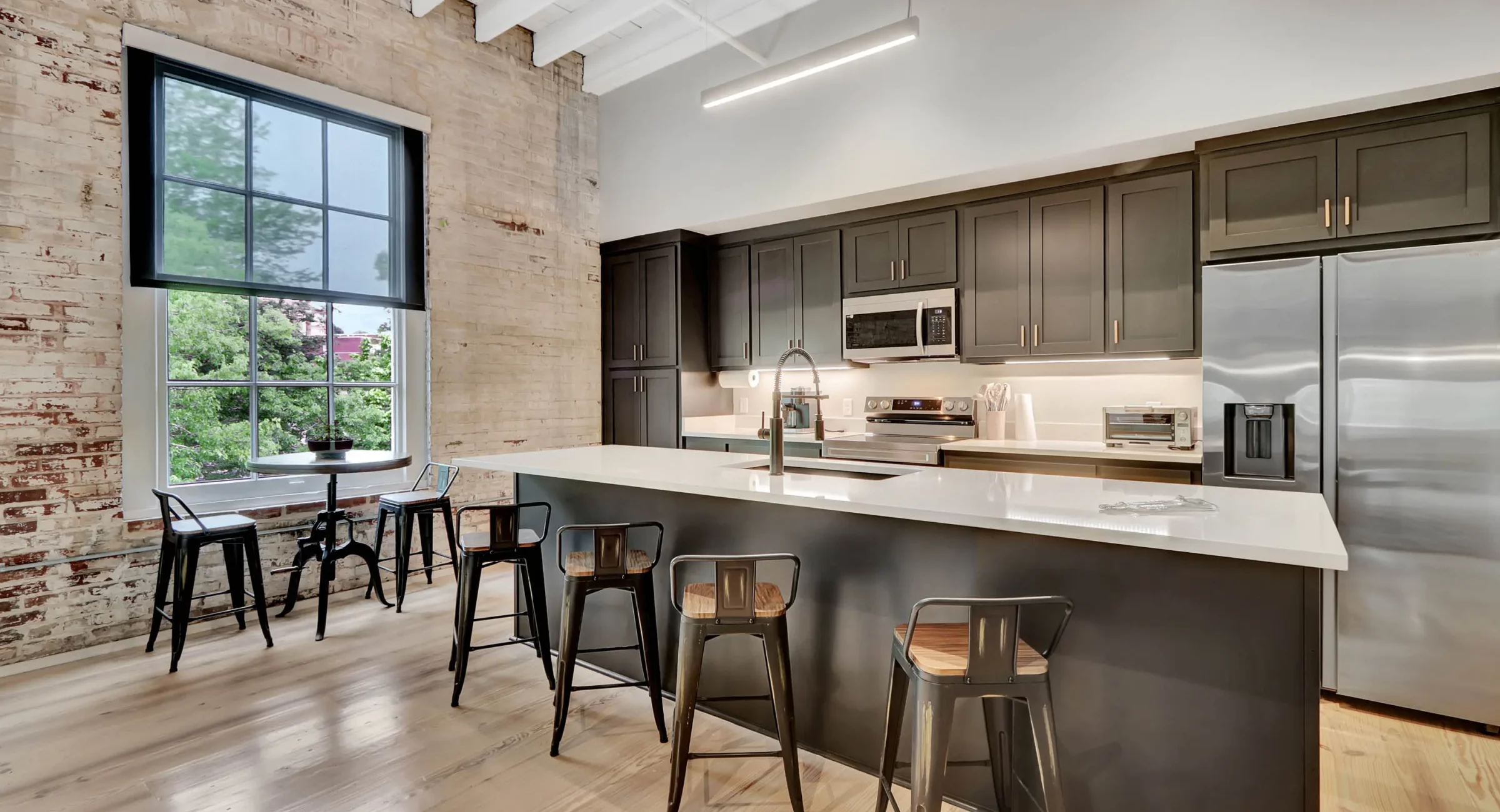 Modern kitchen with island seating inside a historic downtown Hot Springs building