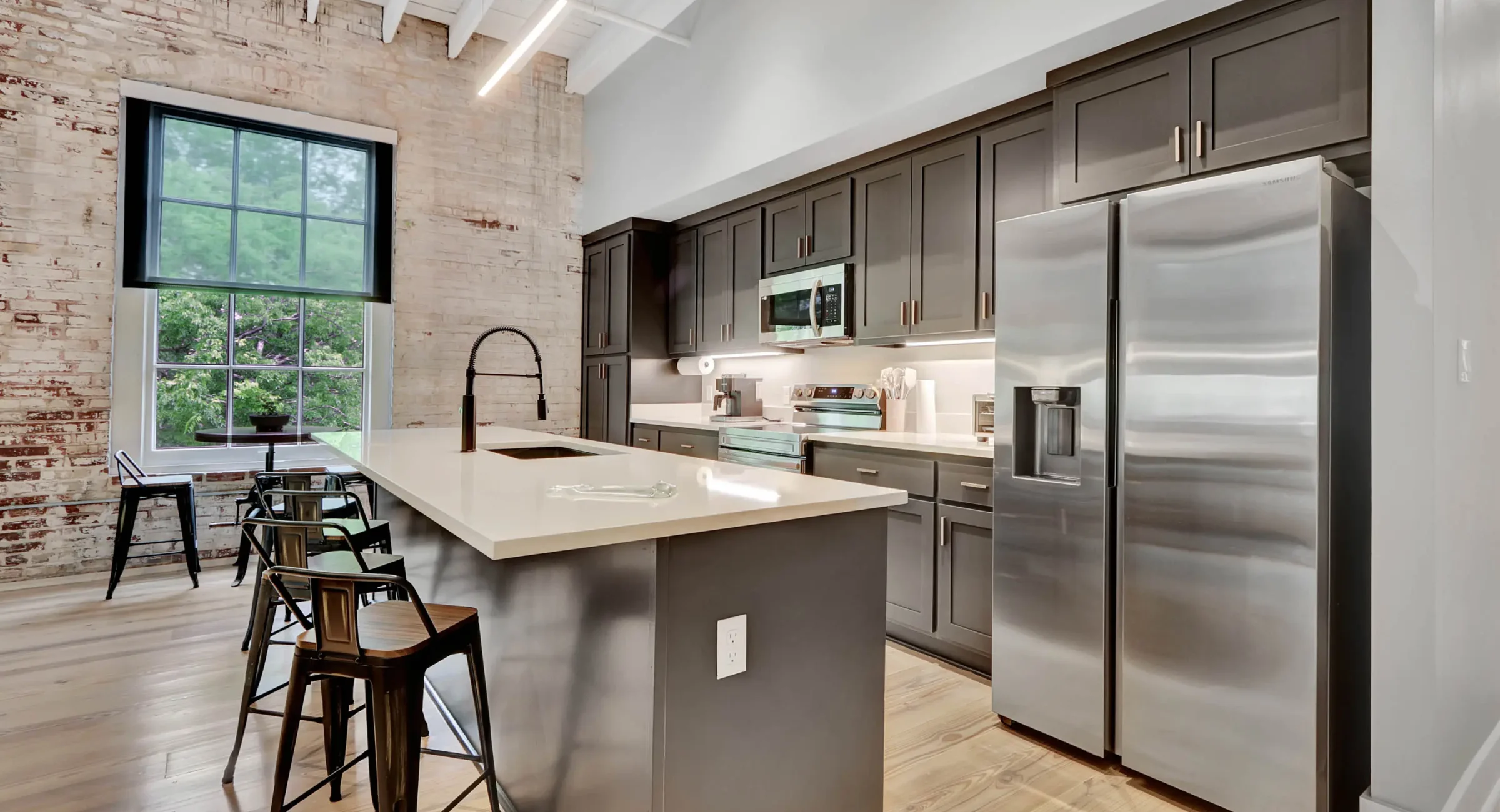 Downtown Hot Springs loft kitchen blending modern finishes with historic structure