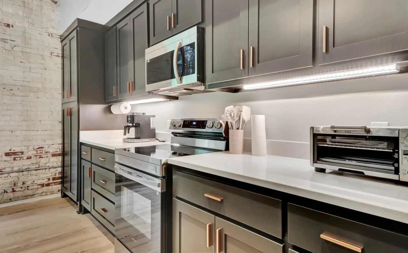 Fully equipped kitchen with stainless steel appliances and quartz countertops
