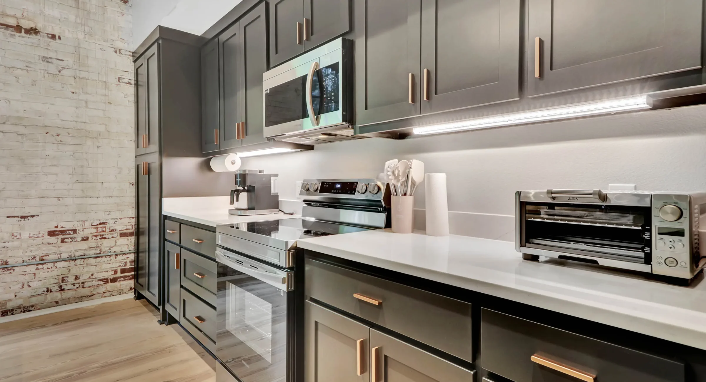 Fully equipped kitchen with stainless steel appliances and quartz countertops