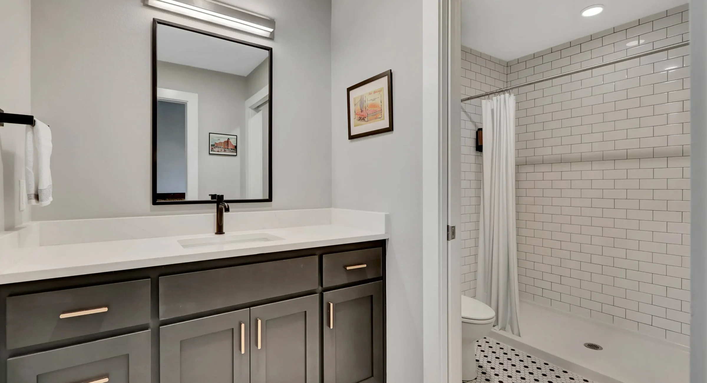 Contemporary bathroom with double vanity and subway tile shower