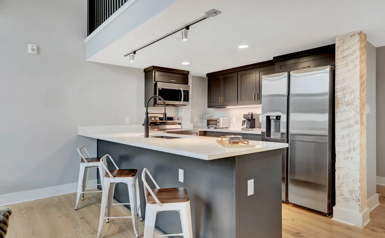 Kitchen and living space with exposed brick walls in downtown Hot Springs lodging