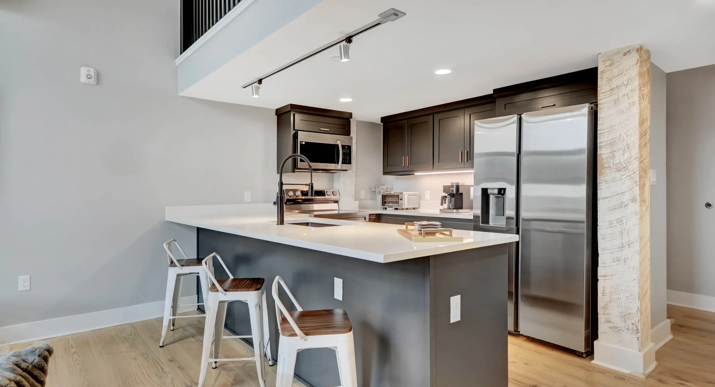 Kitchen and living space with exposed brick walls in downtown Hot Springs lodging