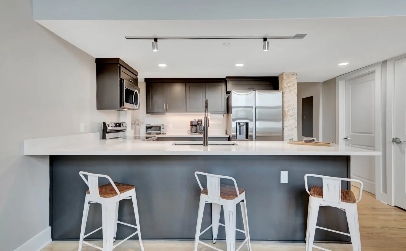 Kitchen island seating with stainless steel appliances in downtown Hot Springs loft