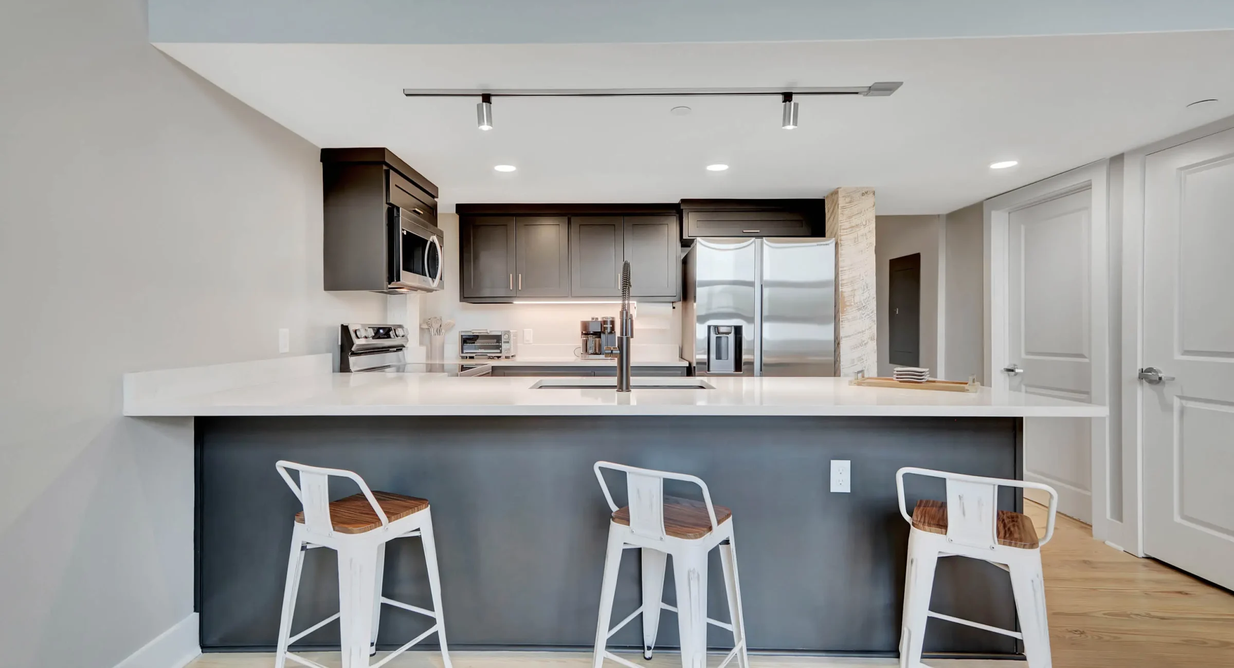 Kitchen island seating with stainless steel appliances in downtown Hot Springs loft