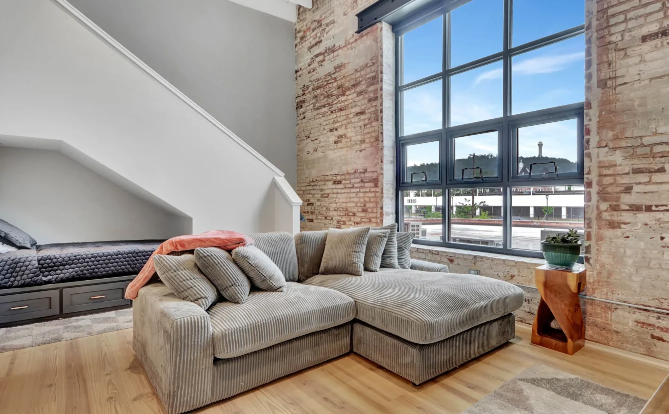 Loft living area with large industrial windows in downtown Hot Springs