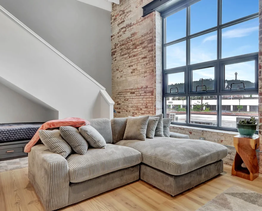 Loft living area with large industrial windows in downtown Hot Springs