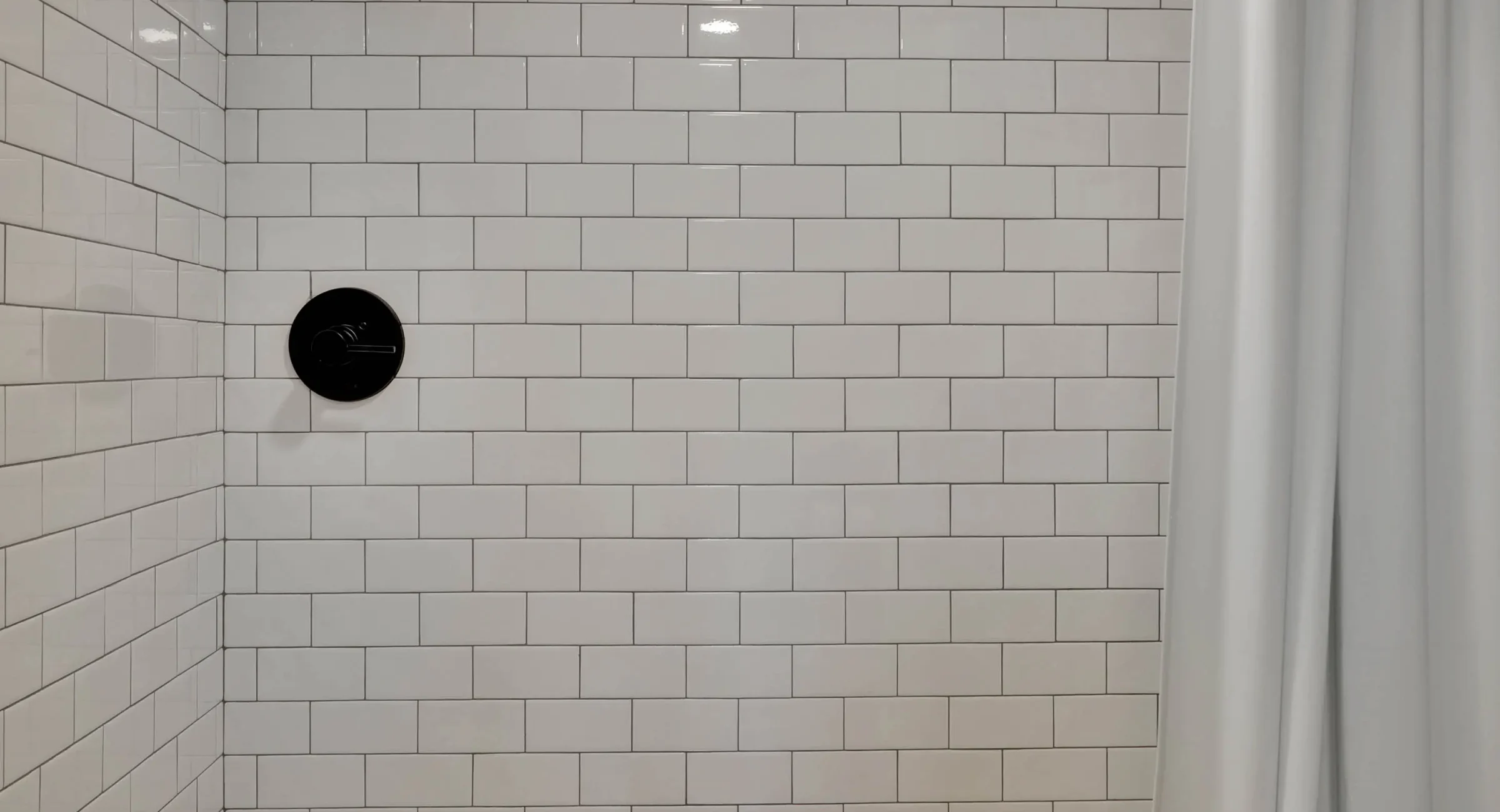 Subway tile walk-in shower with modern fixtures in downtown Hot Springs loft