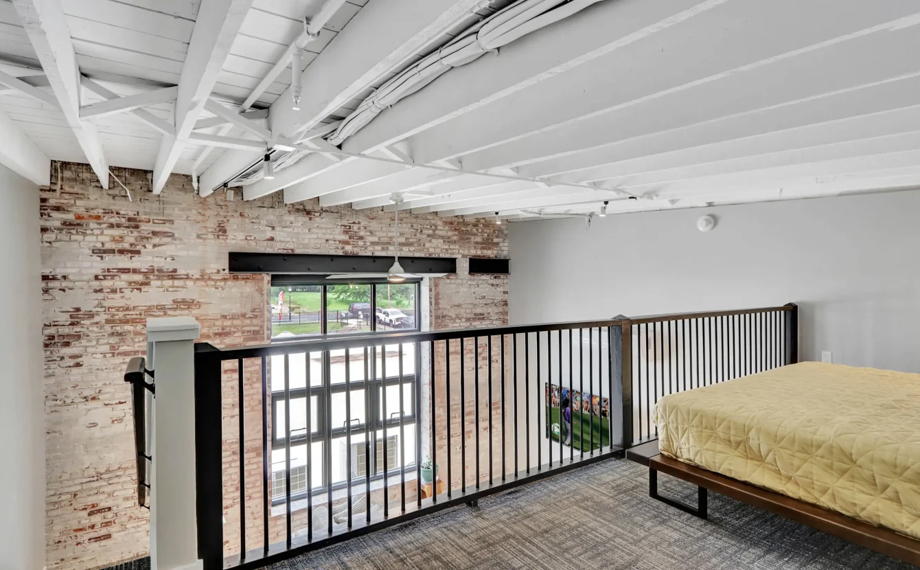 Upper-level sleeping area overlooking living space in downtown Hot Springs loft