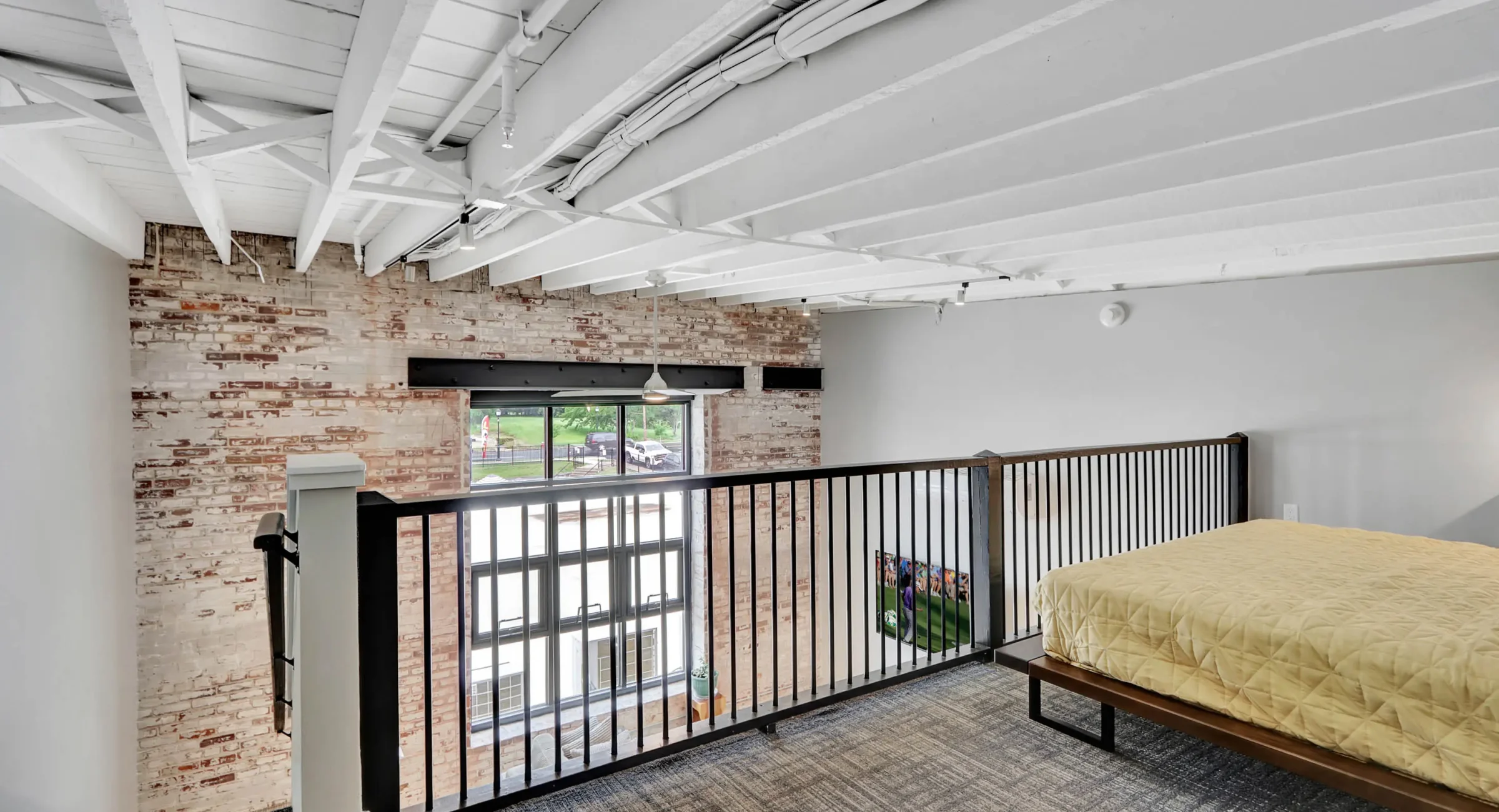 Upper-level sleeping area overlooking living space in downtown Hot Springs loft