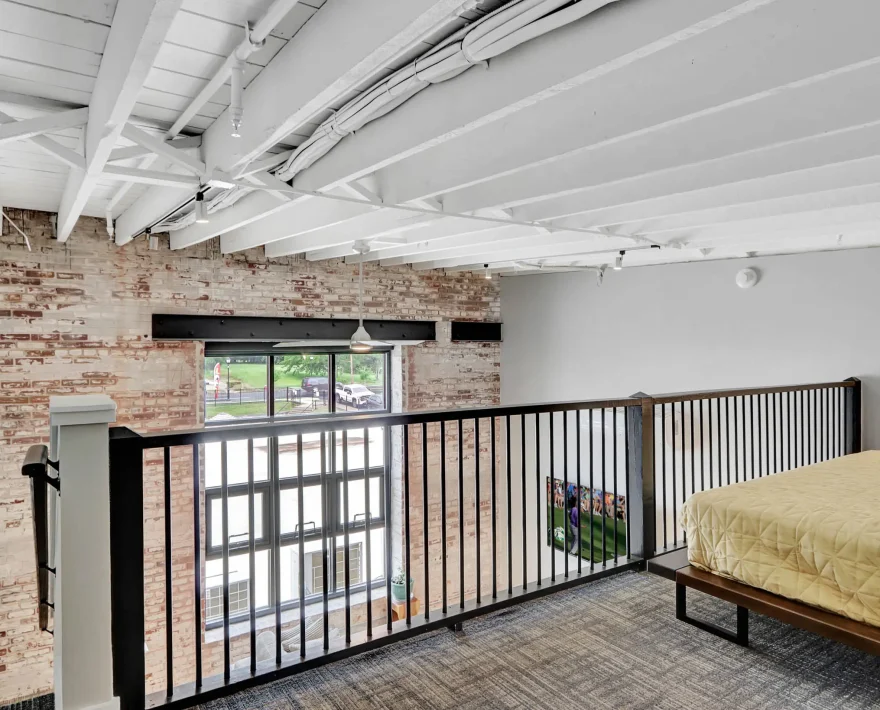 Upper-level sleeping area overlooking living space in downtown Hot Springs loft