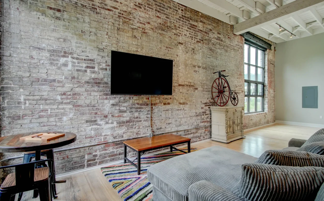Brick accent wall and seating area in historic Hot Springs loft