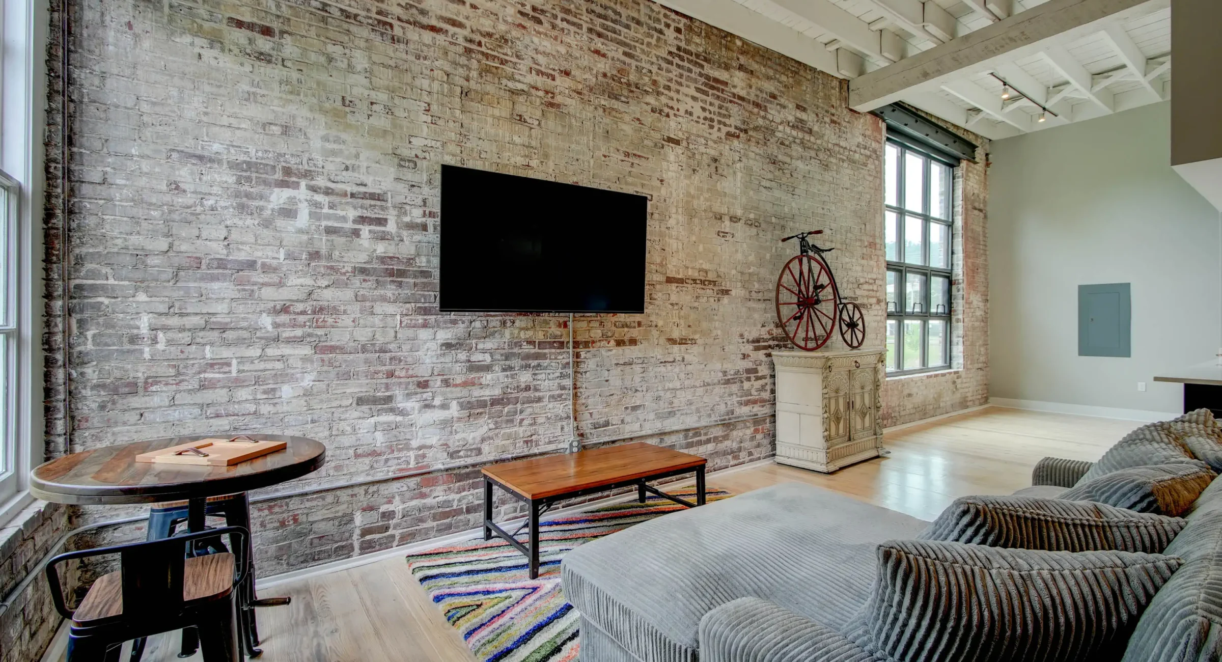 Brick accent wall and seating area in historic Hot Springs loft